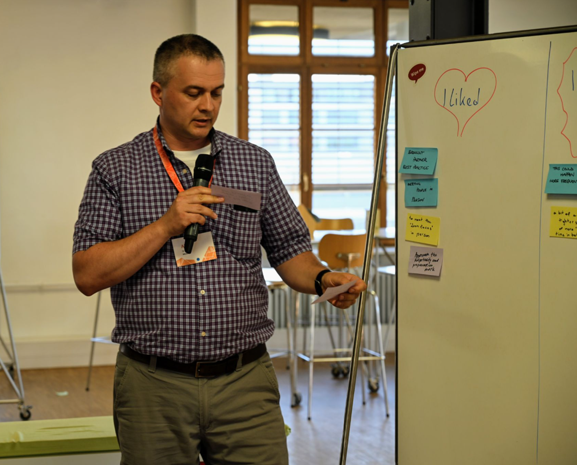 Alex Grinyayev presenting at a workshop, microphone in hand